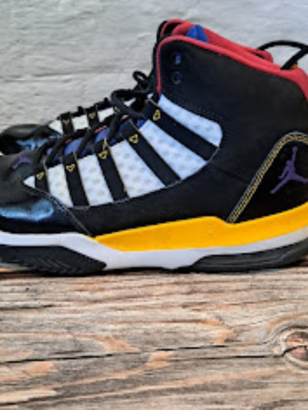 Air Jordan Max Aura Rivals shoes in black leather upper with red yellow and blue